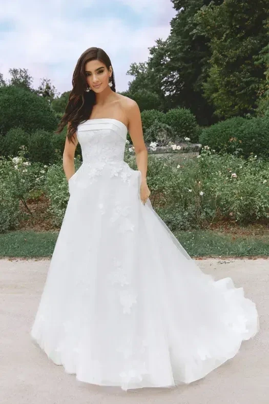 Model wearing a white gown by Sincerity